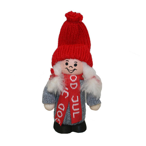 A small Tomte girl figurine with a red knit hat, grey dress, and red "God Jul" scarf.