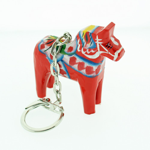 Red wooden Dala horse key ring with traditional white, blue, and yellow painted patterns, attached to a silver metal keyring.