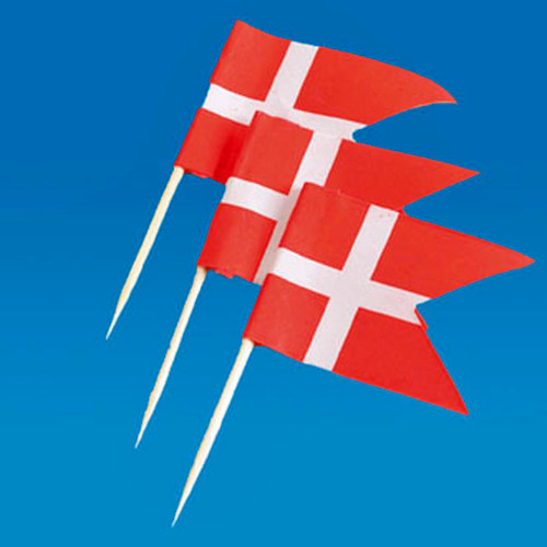 Three small Danish flags on wooden toothpicks against a blue background.