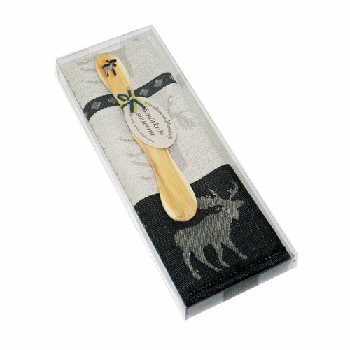 A Skandinavisk Hemslojd black moose-themed kitchen towel and wooden butter knife in a clear plastic gift box.