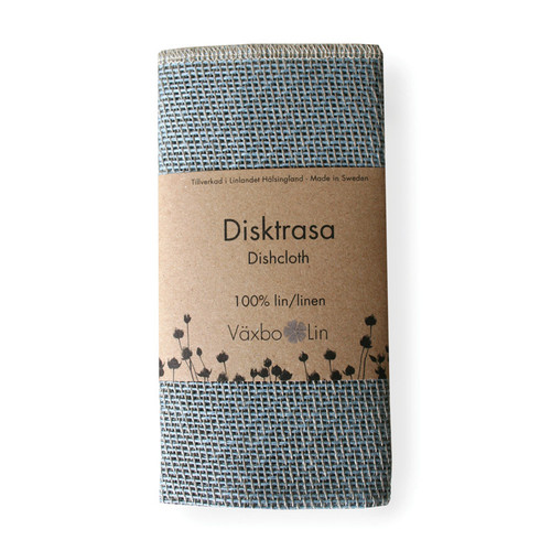Folded light blue linen dishcloth wrapped in a paper band with Växbo Lin branding.