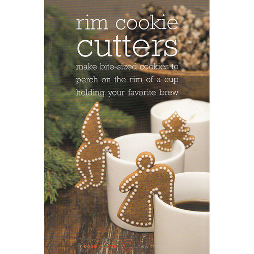 Gingerbread cookies shaped like an angel, gnome, and tree perched on white mugs.