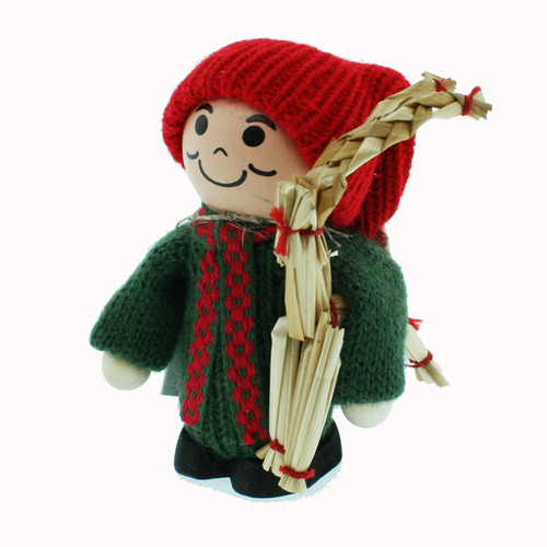 Wooden tomte figure in red knit hat, green coat, holding a straw julbock goat.