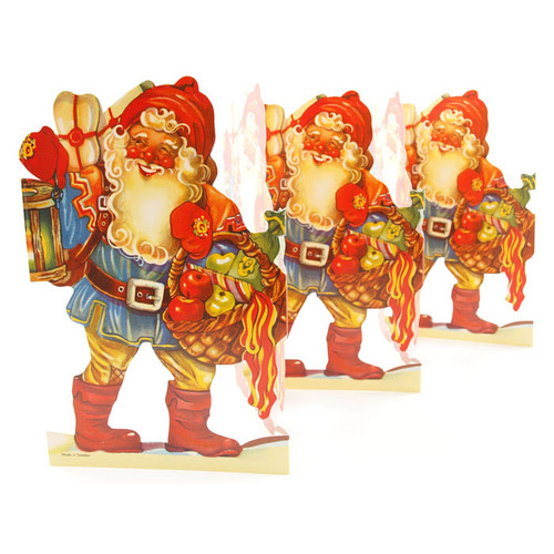Three overlapping vintage paper cutouts of a smiling Scandinavian Tomte holding a basket and lantern.