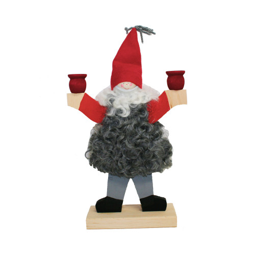 Handmade Swedish wooden candleholder shaped like a gnome in a vest and red hat, holding two red candle cups.