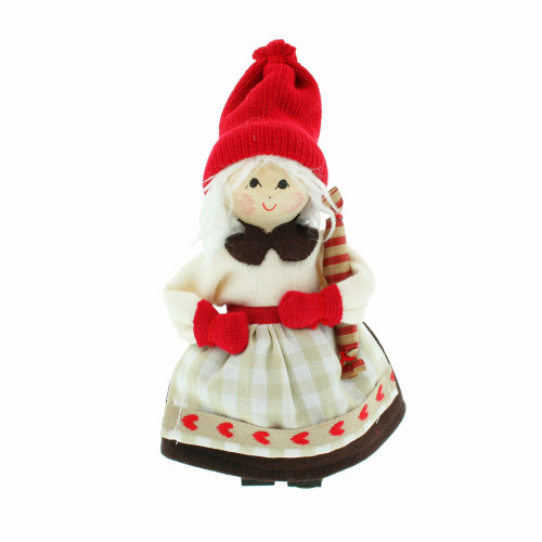 Swedish Tomte lady doll wearing a red hat, white sweater, and checked skirt, holding a striped present.