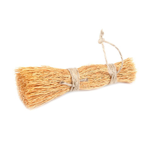 An Iris Hantverk cereal root washing up whisk pot brush with natural fibers and twine bindings, isolated on white.