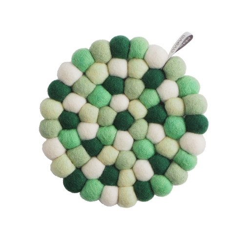 Circular wool felt ball trivet in a mix of green, white, and dark green shades.
