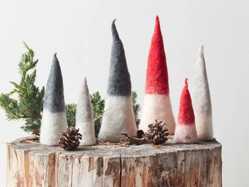 Set of 3 red-and-white wool pixie figurines standing on a tree stump.