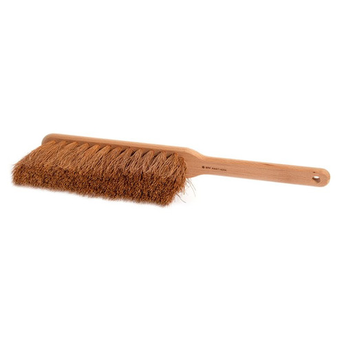 An oiled beech wood hand broom with thick, brown coconut fiber bristles.