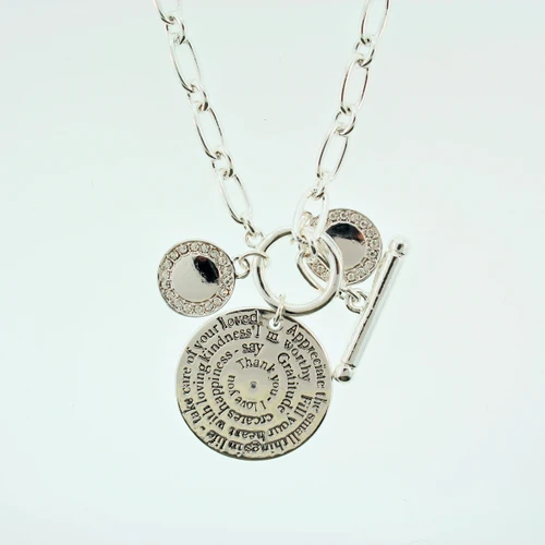 Silver necklace with round pendant and crystal charms.