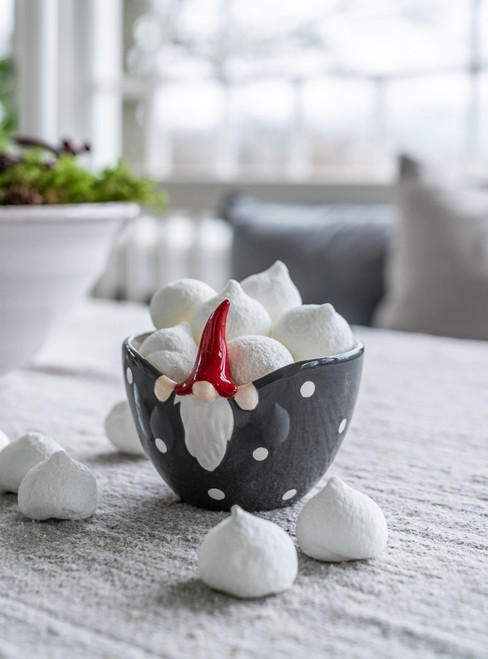 Grey ceramic Tomte bowl with white polka dots and a red gnome hat filled with meringues.