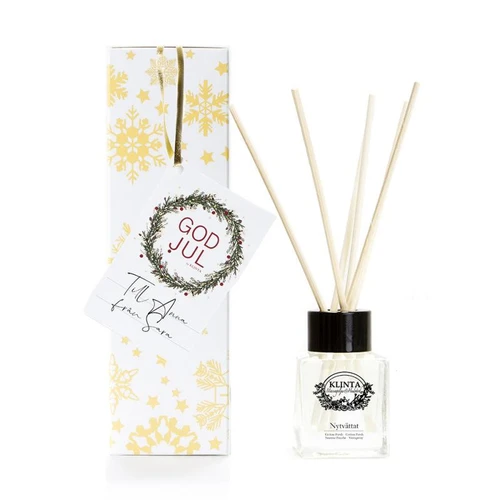 Klinta Cotton Fresh reed diffuser with glass bottle, black cap, reeds, and gift box with gold snowflakes.