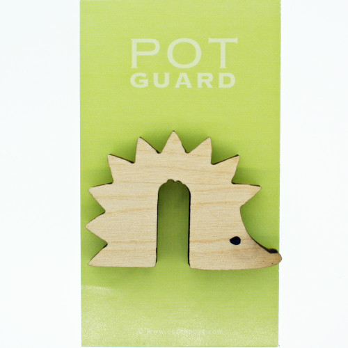 A wooden hedgehog-shaped pot guard on light green packaging with white text.