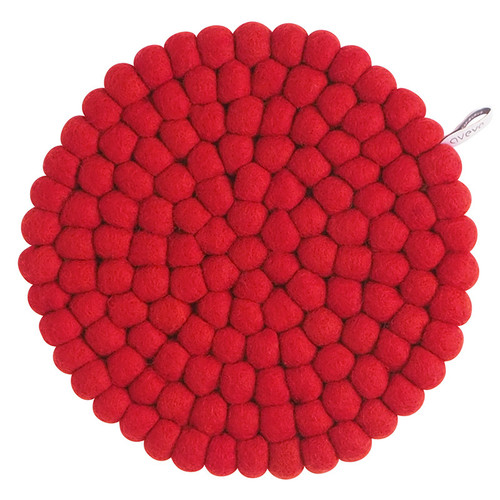 A large round red wool felt ball trivet seen from above, with a small hanging loop.