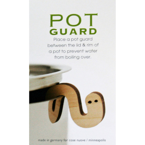Wooden worm-shaped pot guard propped on a pot rim under a lid, with packaging text above.