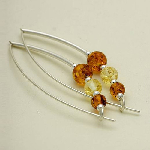 Two silver long-back earrings with amber and yellow gemstone beads.