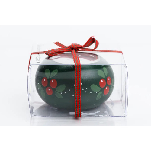 Green wooden candleholder with hand-painted lingonberry motif inside a clear gift box tied with a red ribbon.
