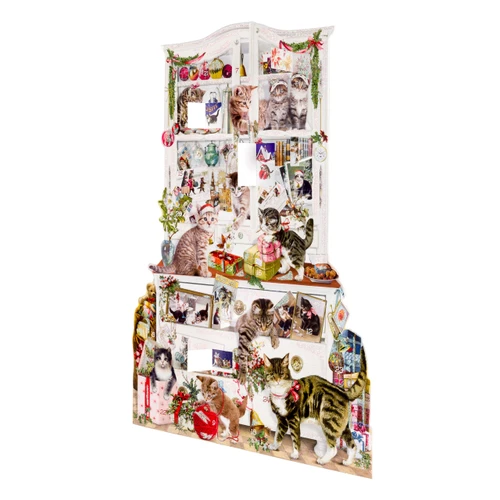 Die-cut Christmas cat advent calendar with glitter accents, showing playful felines on a white cabinet.