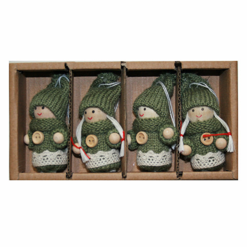 Four green knitted Tomte boy and girl ornaments with wooden faces in a cardboard box.