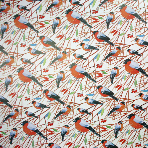 Scandinavian wrapping paper with bullfinches on branches.
