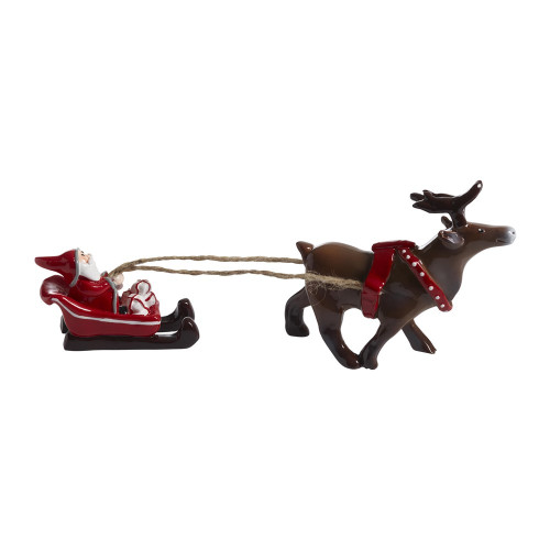 Ceramic tomte in a red sleigh attached by twine to a brown reindeer figurine.