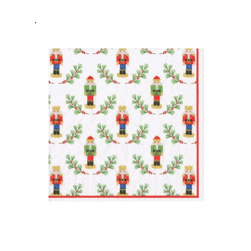White cocktail napkin with a pattern of traditional nutcrackers and pine branches.