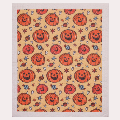 Orange Swedish dishcloth with a pattern of smiling jack-o'-lanterns, stars, and candy.