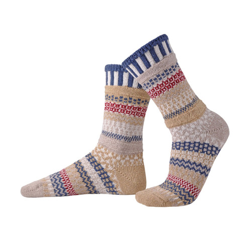 Two knit crew socks in mismatched patterns of tan, blue, red, and white.