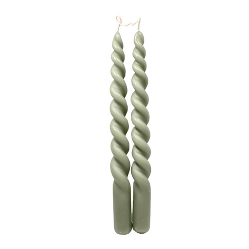 Two sage green twisted taper candles connected by their wicks.