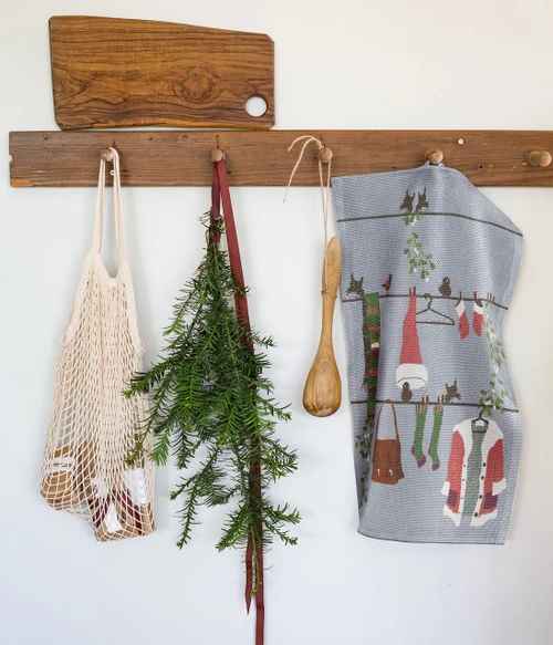 Hanging blue patterned kitchen towel featuring a festive Nordic holiday motif.
