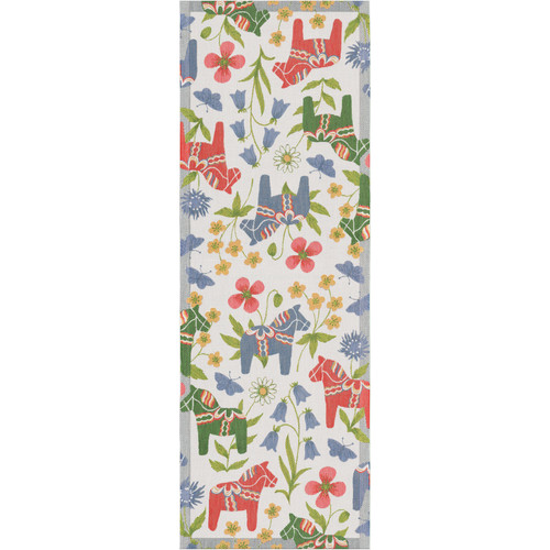 Ekelund Blomsterhast table runner. White cotton with colorful floral and Dala horse pattern. Rectangular, top-down view.
