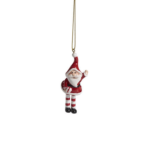 Red and white ceramic Santa ornament, waving, with striped legs, hanging by gold string.