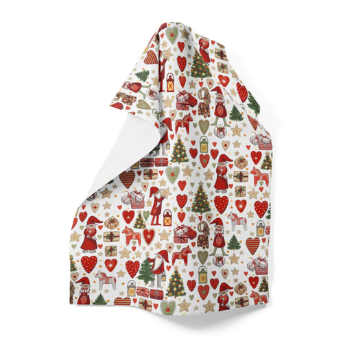 White cotton tea towel with a Christmas pattern of red, green, and gold elements, folded at an angle.