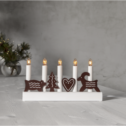 White wooden candelabra with 5 electric candles and gingerbread-style wooden figures.