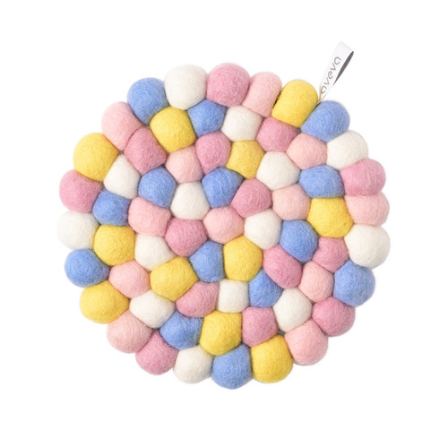 Round wool trivet in a colorful mosaic pattern. Features pink, yellow, blue, and white felt balls. Aveva Design tag.