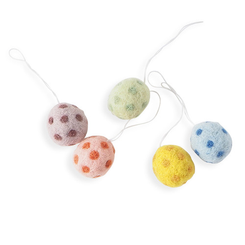 Five felt egg ornaments in pastel colors with dotted patterns, hanging by white strings.