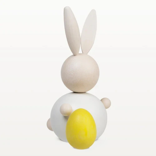 White wooden rabbit figurine with yellow egg, maple, handmade.