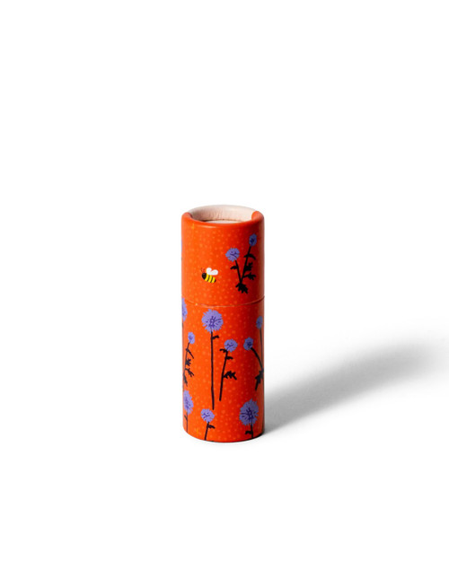 Orange tube lip balm with blue flowers and a bee design.