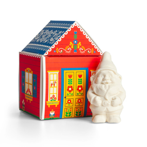 White gnome-shaped soap beside a colorful decorative paper house box.