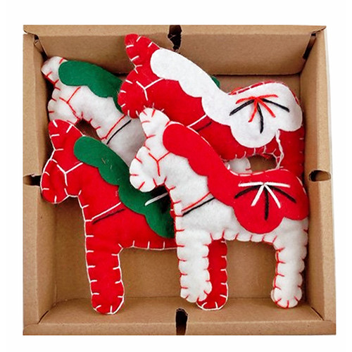 Four handmade felt Dala horse ornaments in red and white with green manes, neatly packed in a cardboard box.