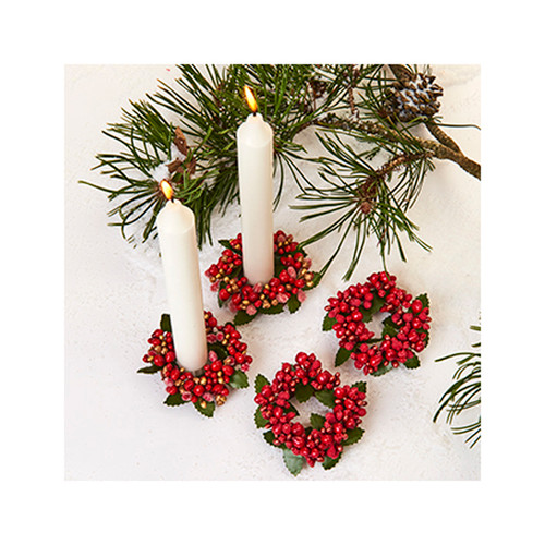 Two lingonberry candle rings made of red berries and green leaves, with lit candles.
