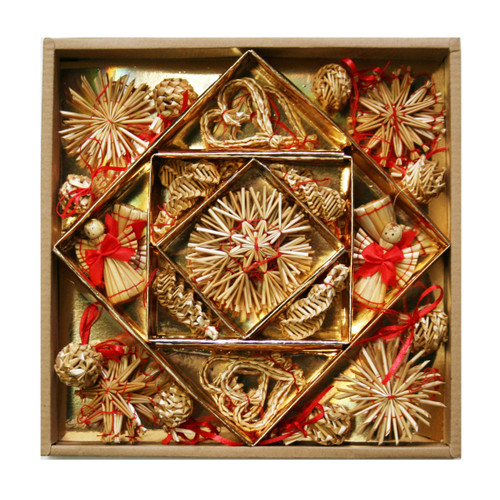 Straw ornaments in a gold-lined box, with red ribbon accents. Natural straw material.