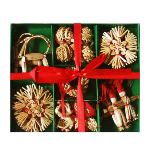 Straw ornament set in a green box, red ribbon, natural straw, red accents, various shapes.