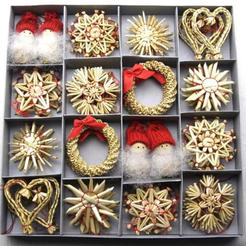 Assortment of straw ornaments in a divided box; includes stars, hearts, wreaths, and Tomte figures. Natural straw, red