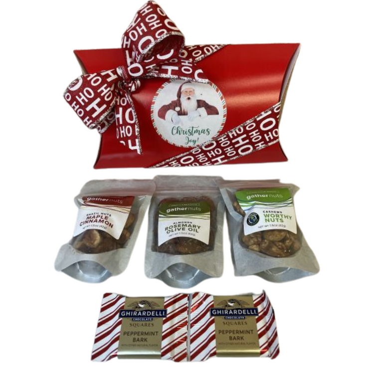 Gather Nuts Holiday Sampler - includes Gather Nuts Rosemary Olive Oil Almonds, Gather Nuts Worthy Cashew Nuts,  Gather Nuts Maple Cinnamon Brazil Nuts and two Ghirardelli peppermint chocolates.  Designed in a red pillow pack with holiday ribbon.  Choose your preferred label. This gift can be personalized with your logo instead of our standard holiday label. 