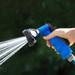 Hand spraying blue hose nozzle