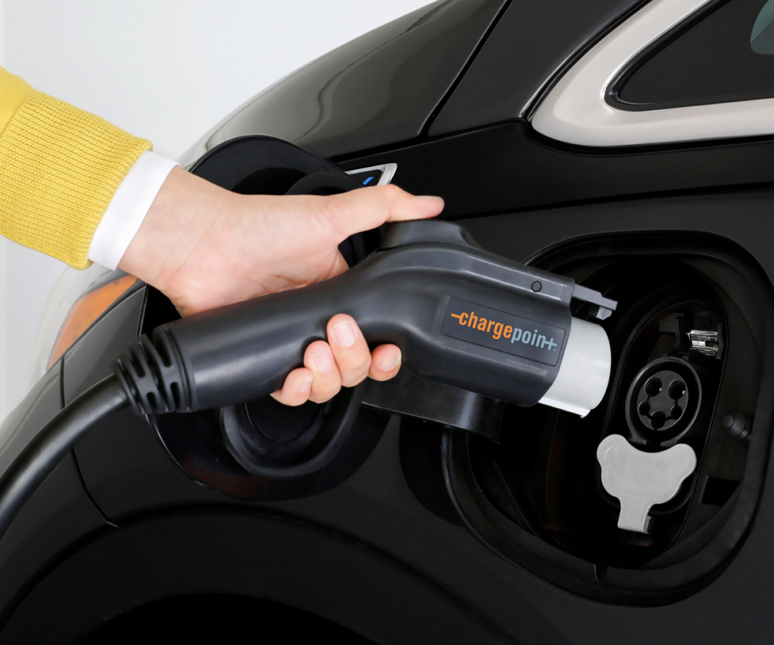 person hand plugging the Chargepoint charger in an electric vehicle