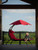 72" Red Low Outdoor Lounge Chair with an Overhanging Umbrella