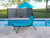 72" Blue Low Outdoor Lounge Chair with an Overhanging Umbrella